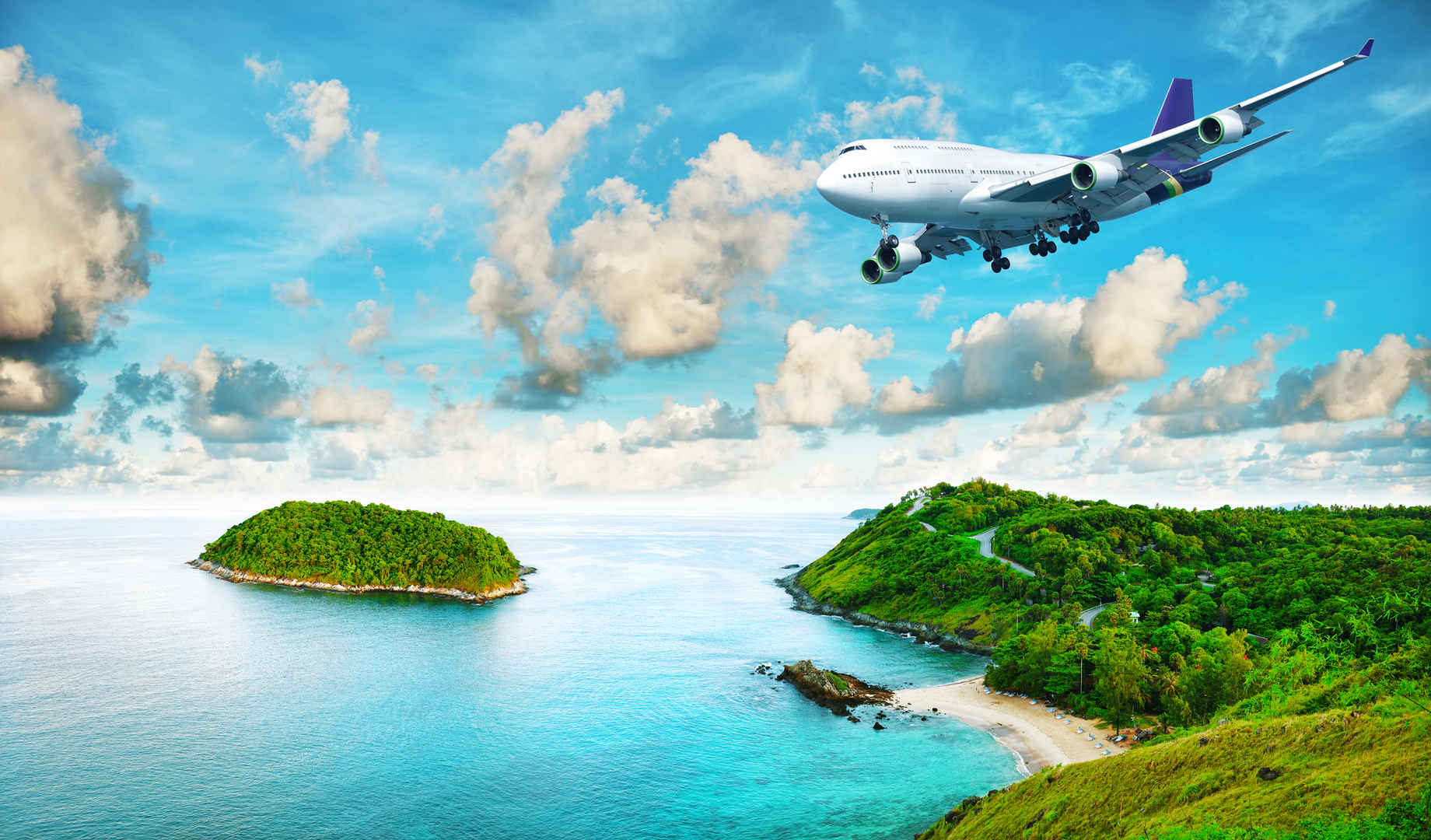 喷气客机飞机飞过热带岛屿图片-